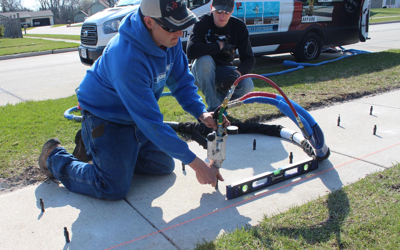 Foam-Tek crew leveling a sidewalk with polyurethane injection